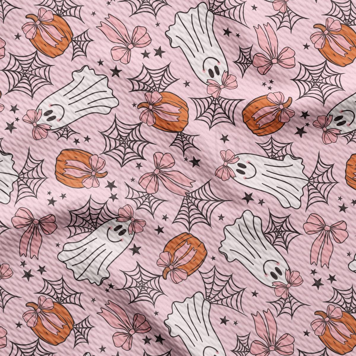 a pink background with halloween decorations on it