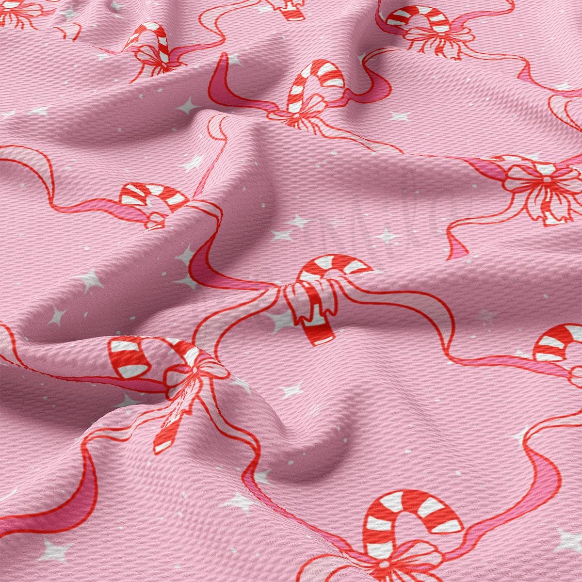 a pink fabric with candy canes on it