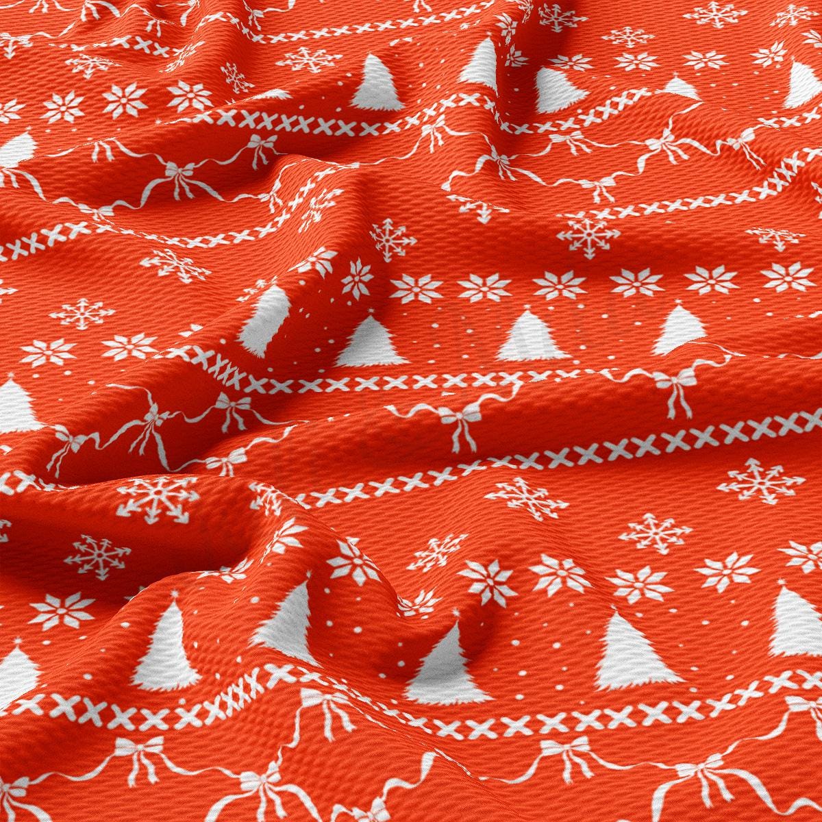 a red fabric with white christmas trees on it