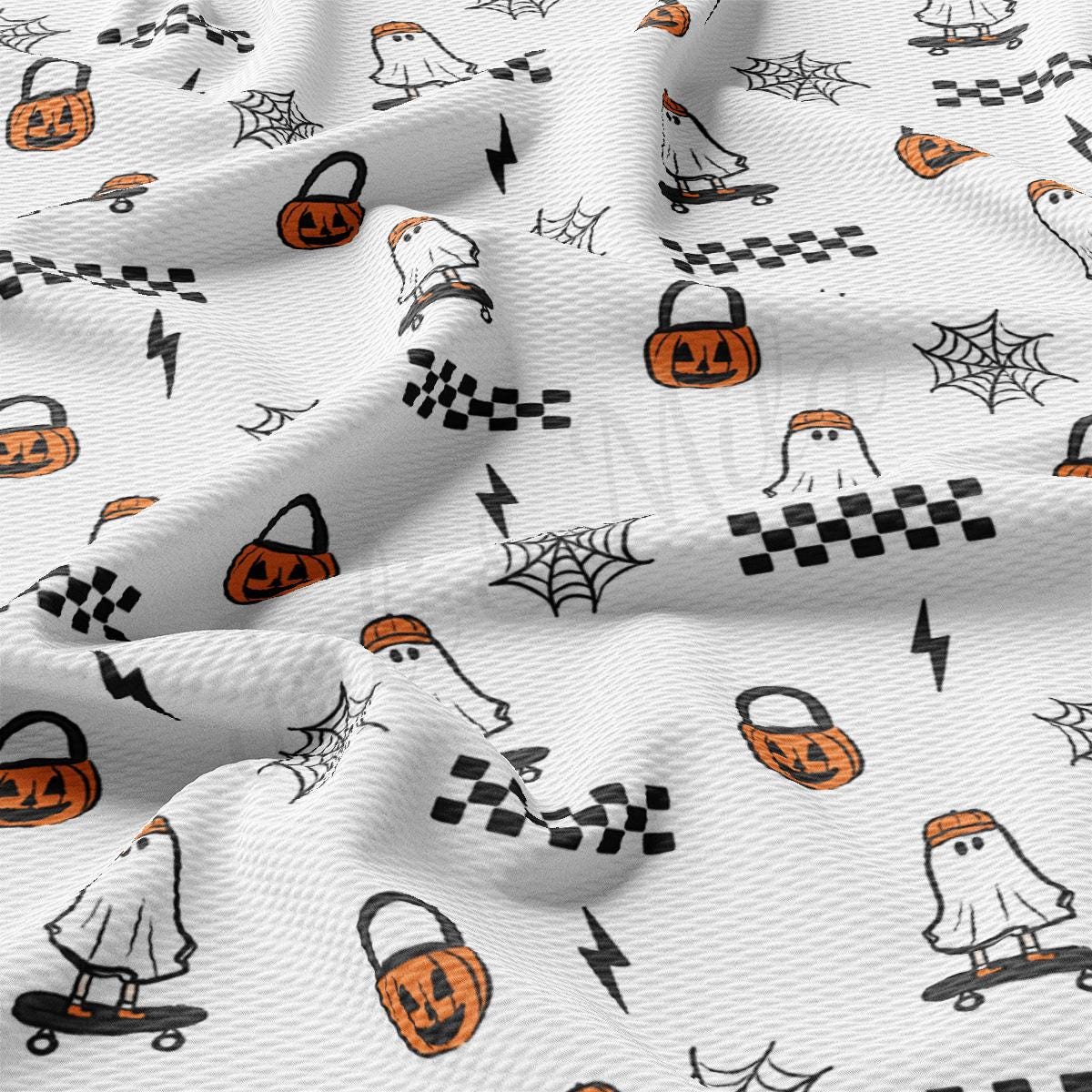 a white fabric with black and orange halloween images