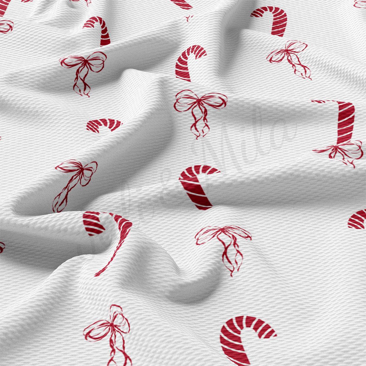 a white fabric with red candy canes on it