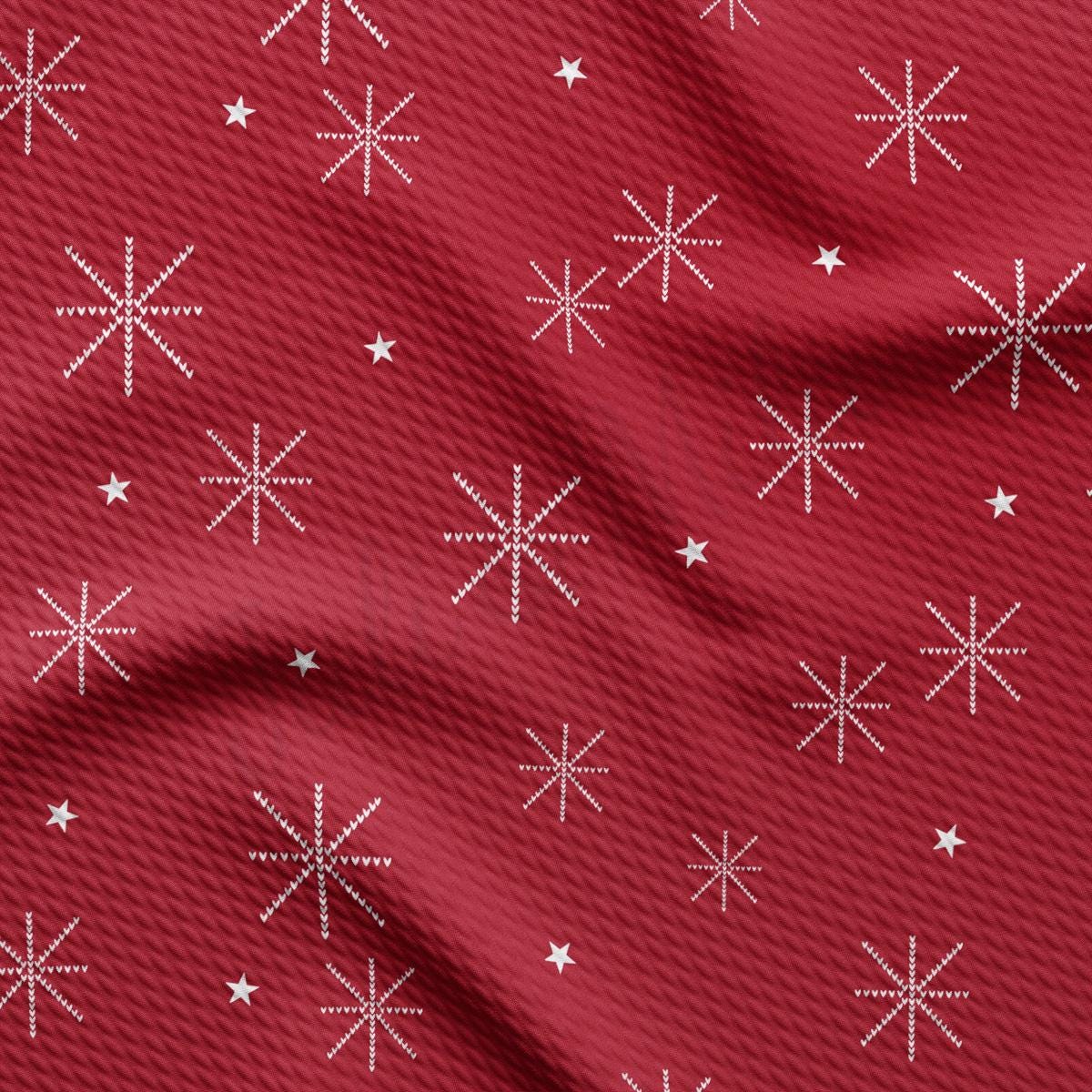 a red fabric with white snowflakes on it