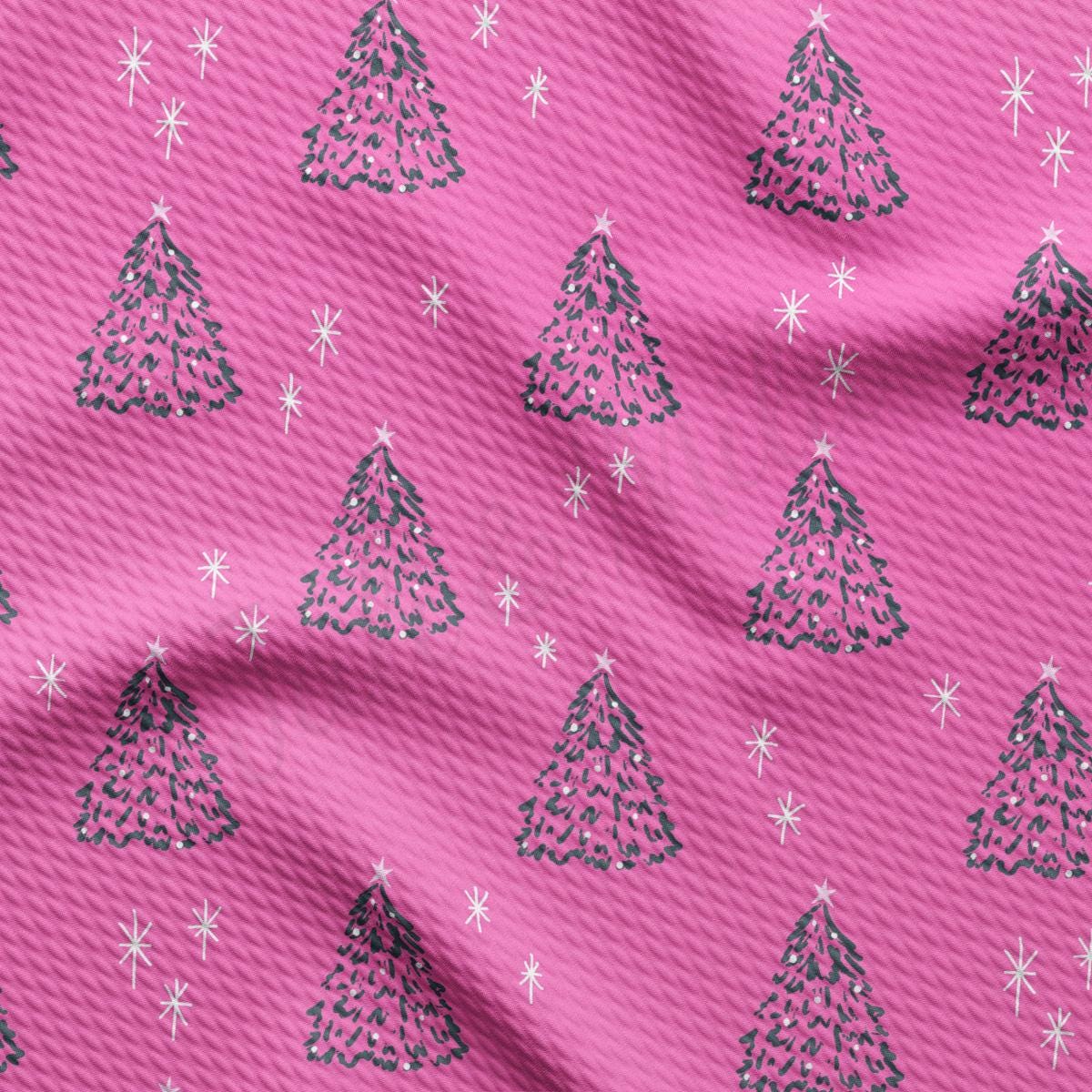 a pink background with a pattern of christmas trees