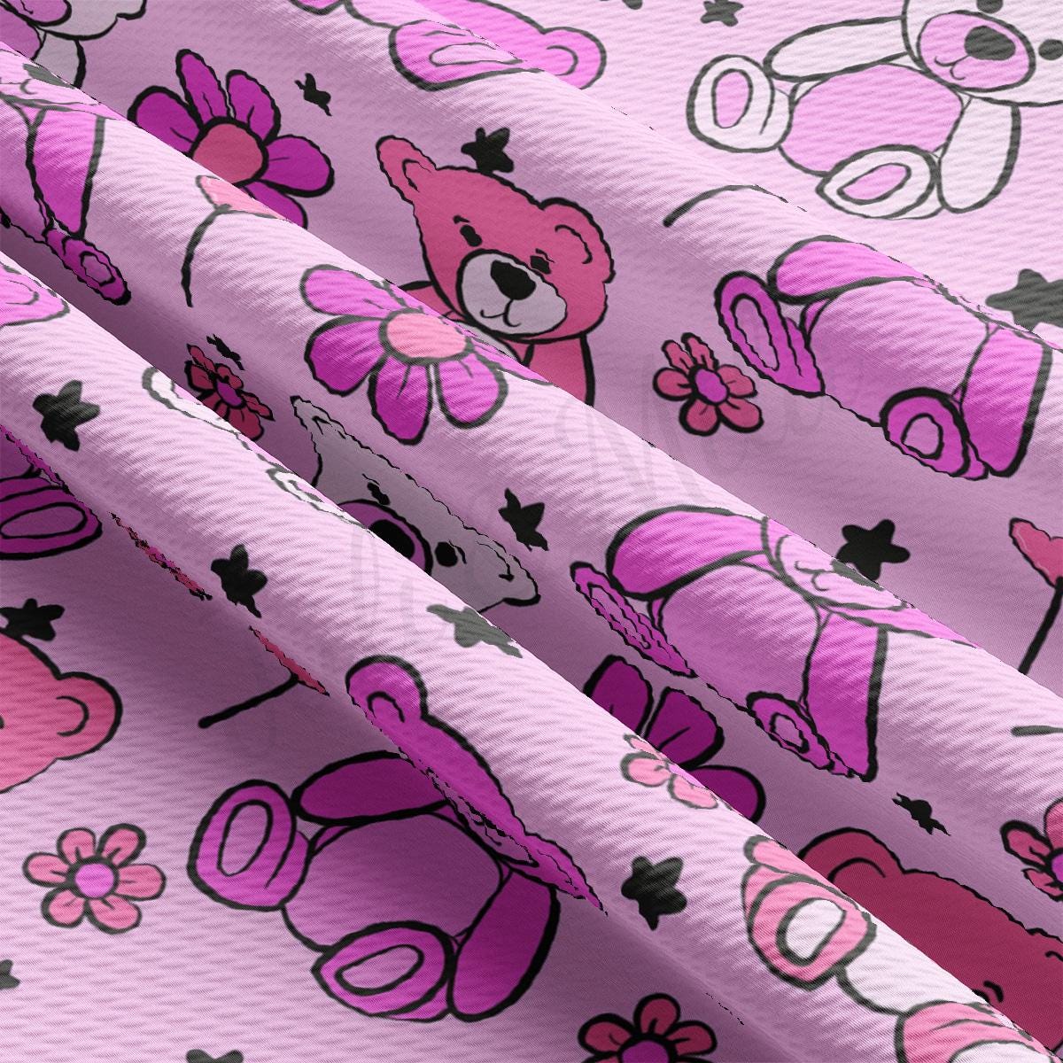 a close up of a pink fabric with a teddy bear pattern