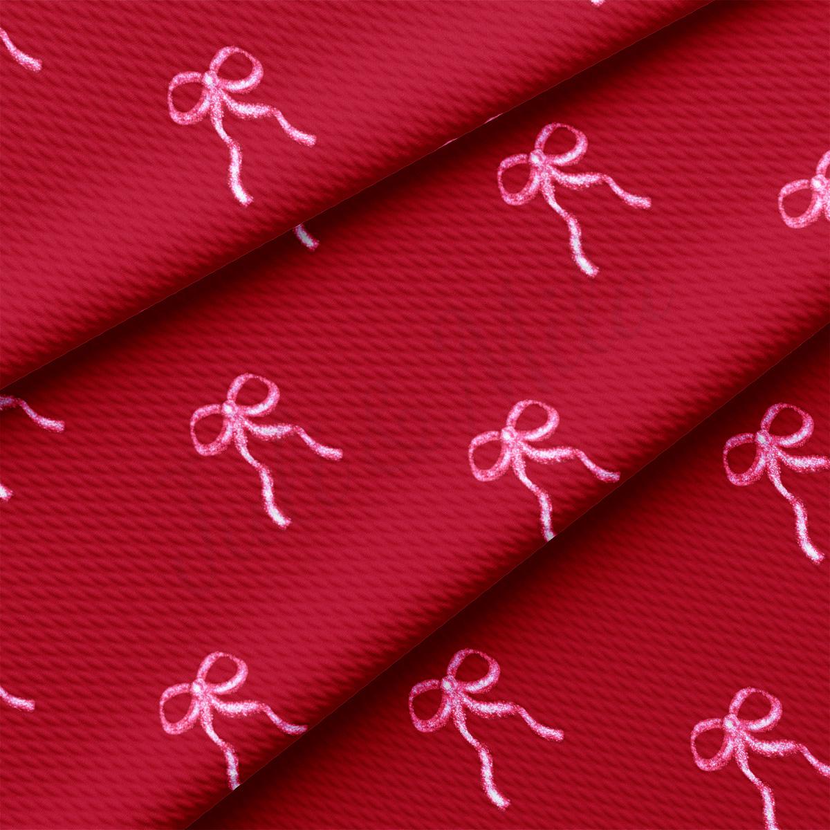 a red fabric with pink bows on it