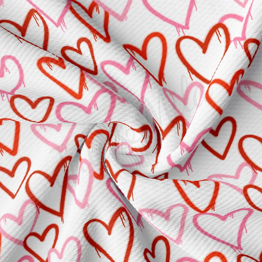 a white fabric with red and pink hearts on it