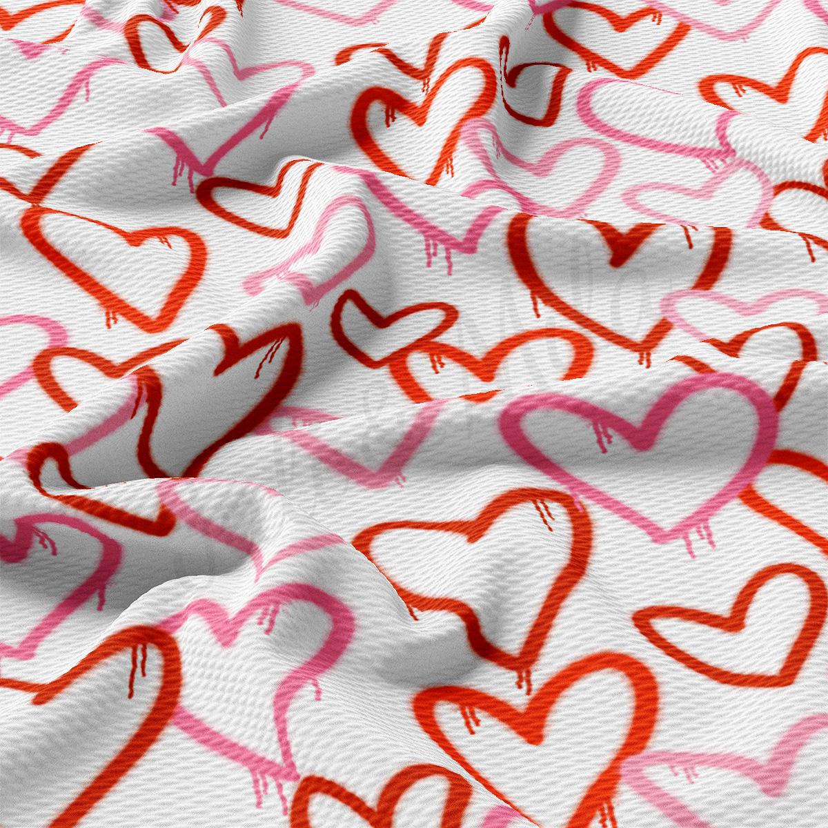 a white fabric with red and pink hearts on it