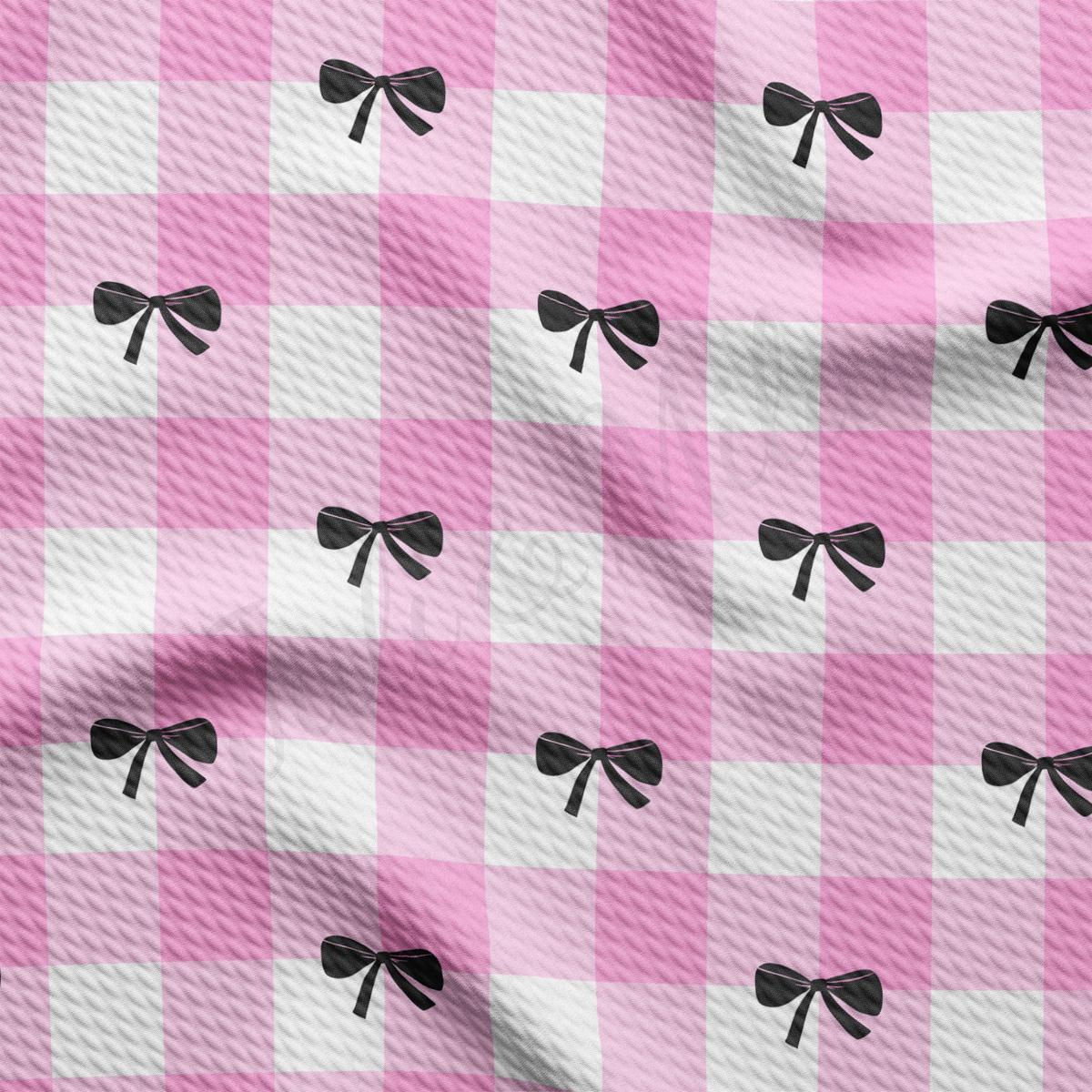 a pink and white checkered fabric with black bows