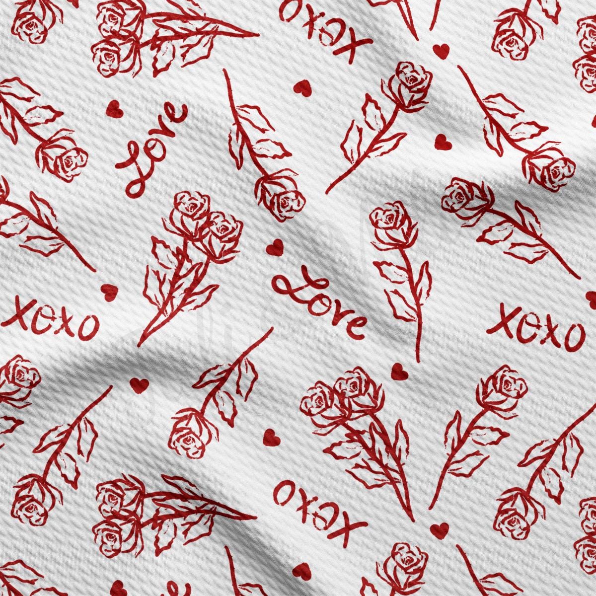 a white fabric with red flowers and hearts on it