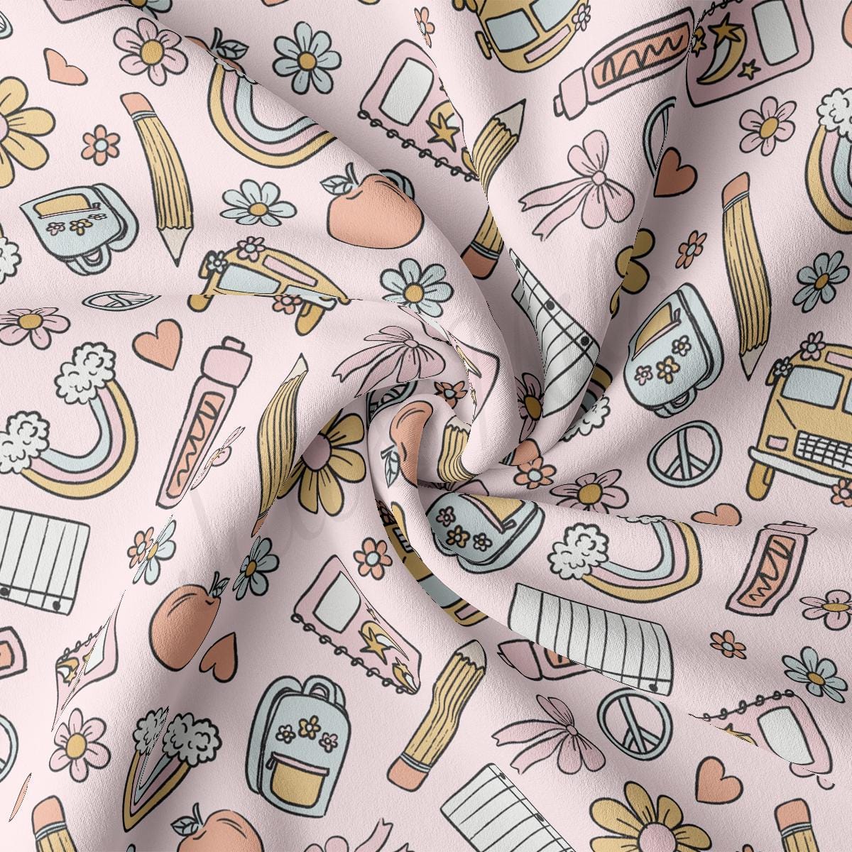 a close up of a pink fabric with various items on it