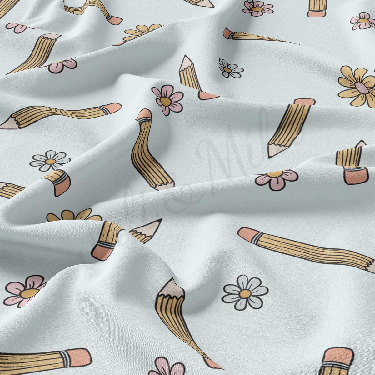 a white fabric with a flower and pencils on it