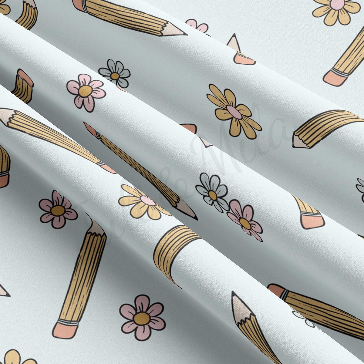 a close up of a pattern of pencils and flowers