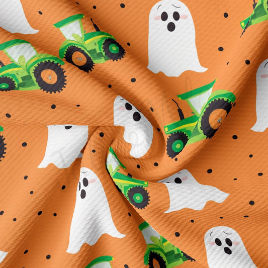 a close up of a pattern of a tractor and ghost on an orange background