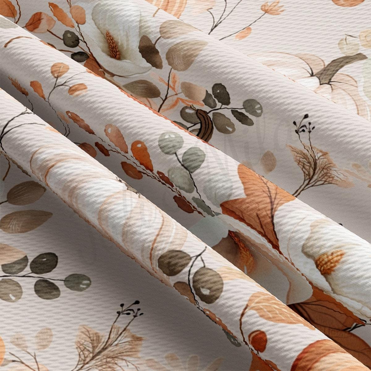 a close up of a flowered curtain with leaves on it