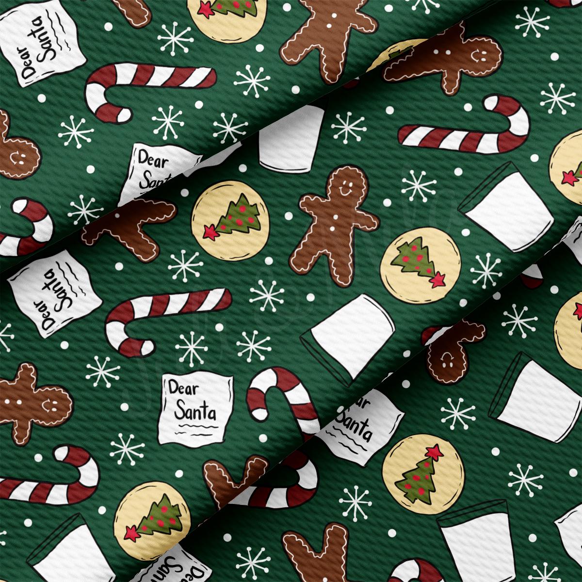 a green christmas wrapping paper with gingerbreads and candy canes