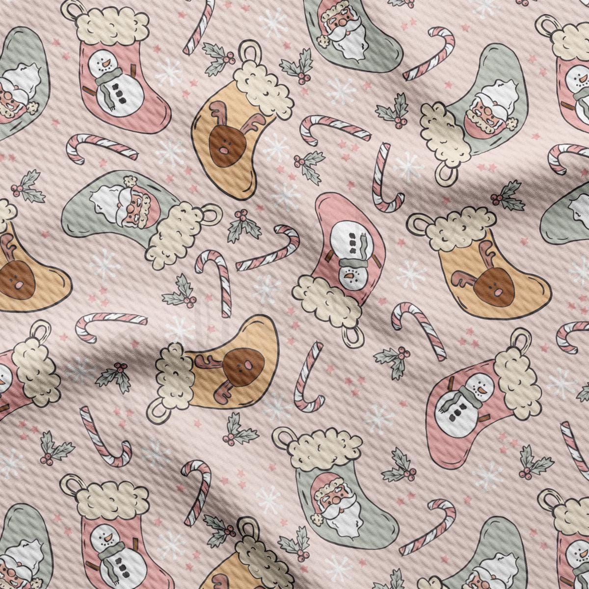 a pink fabric with a pattern of santa and snowmen