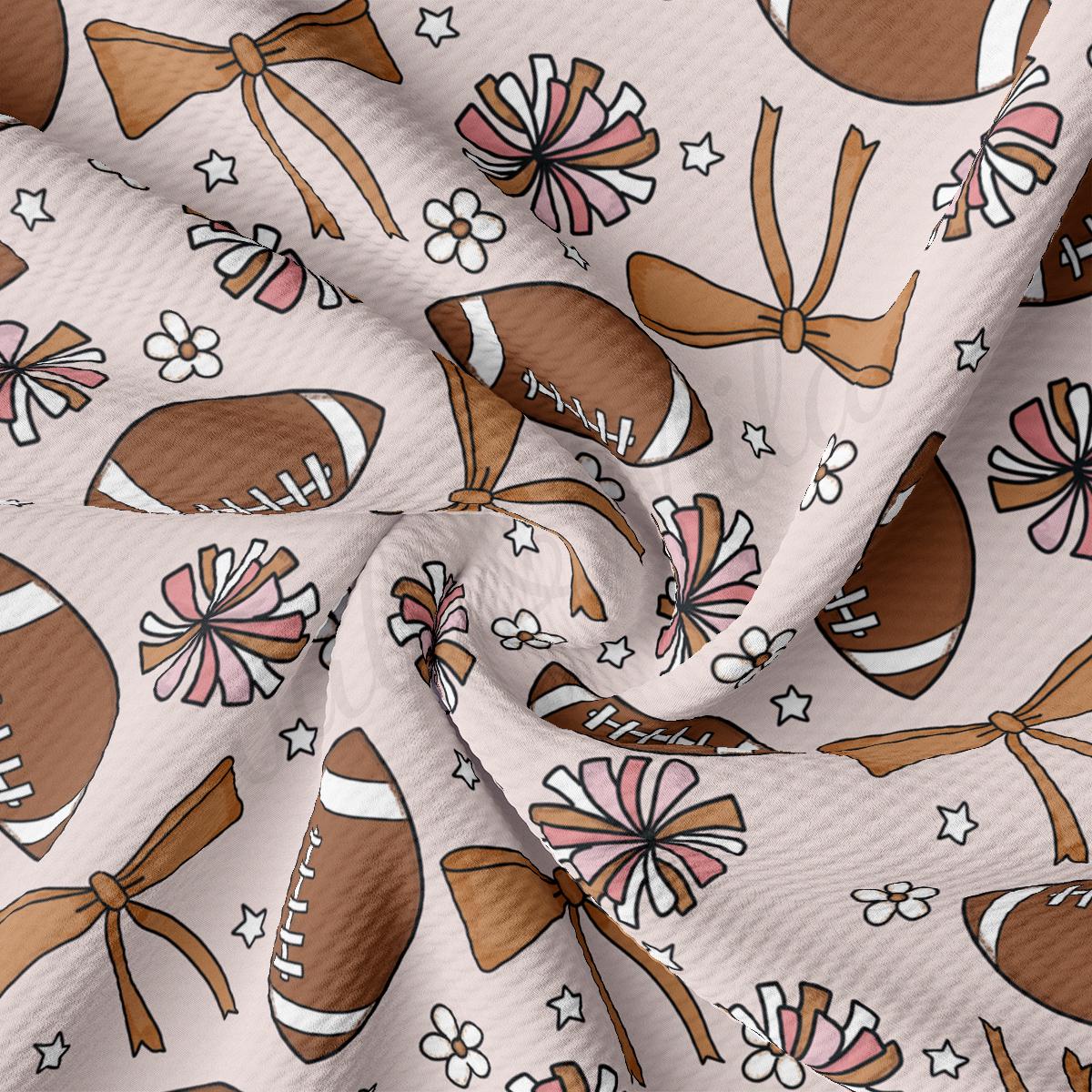 a white fabric with a pattern of footballs and bows