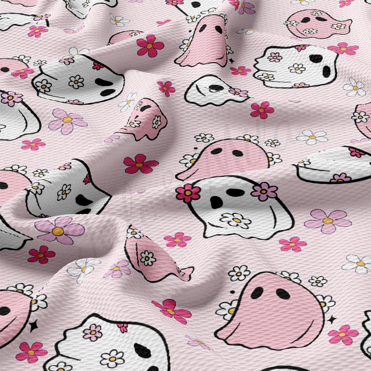 a pink fabric with skulls and flowers on it