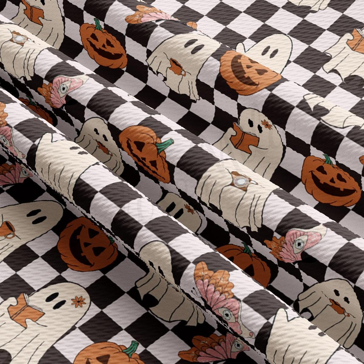 a black and white checkered table cloth with pumpkins and ghost