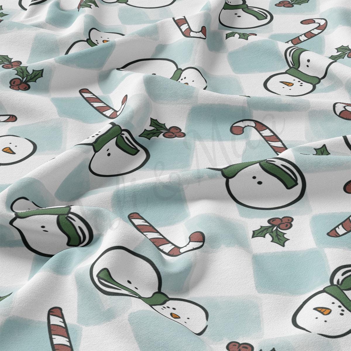 a blue and white checkered fabric with snowmen and candy canes