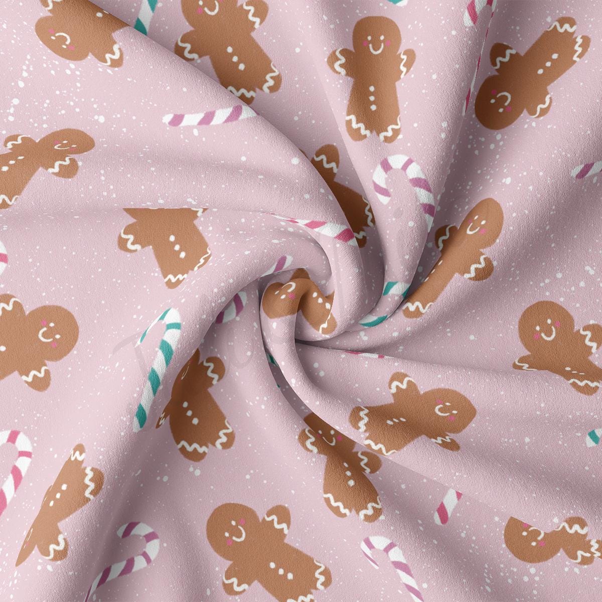 a close up of a pink fabric with gingerbreads on it
