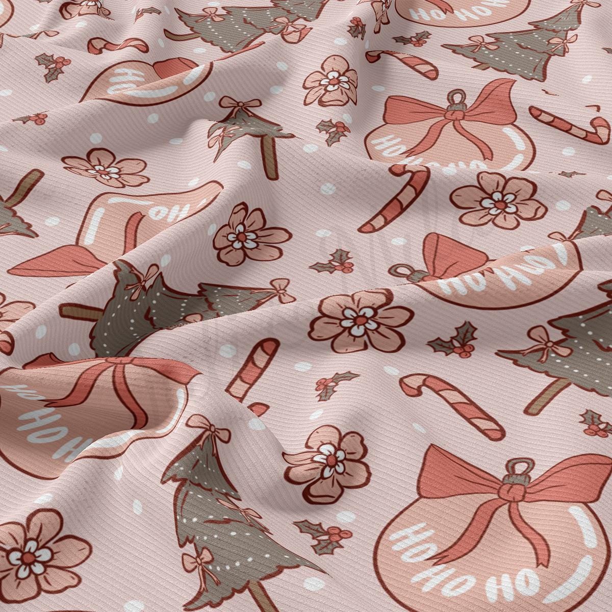 a close up of a pink fabric with christmas decorations on it