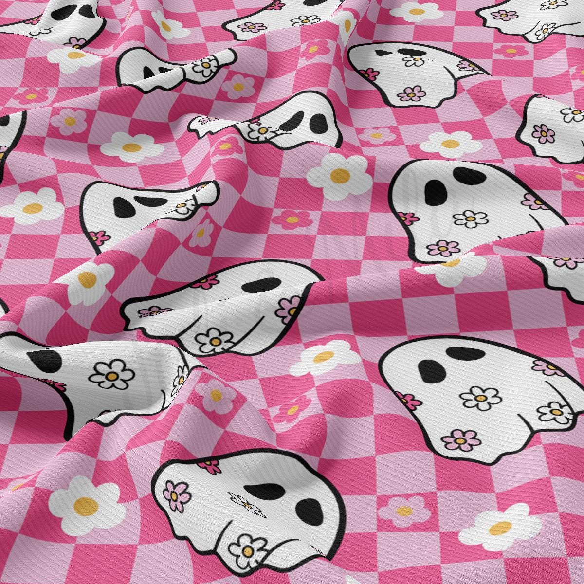 a pink and white checkered fabric with skulls and flowers