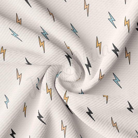 a white fabric with a pattern of lightnings on it
