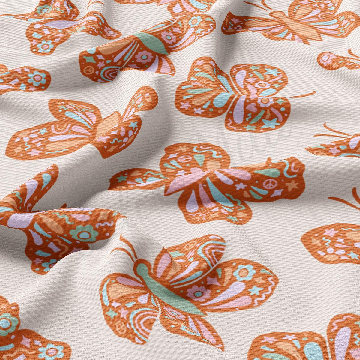 a close up of an orange and white butterfly print fabric