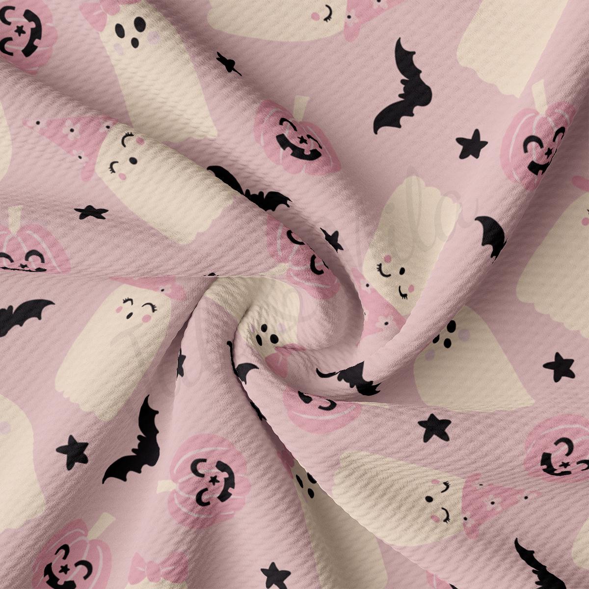 a pink background with black and white skulls and bats