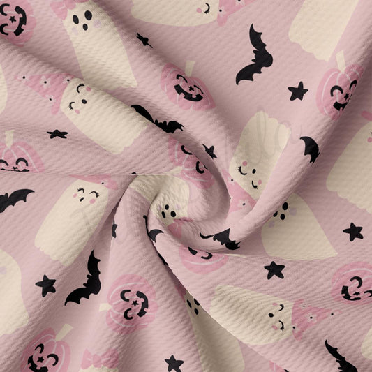 a pink background with black and white skulls and bats