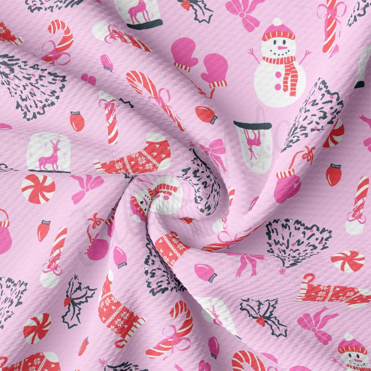 a pink fabric with a snowman and candy canes on it