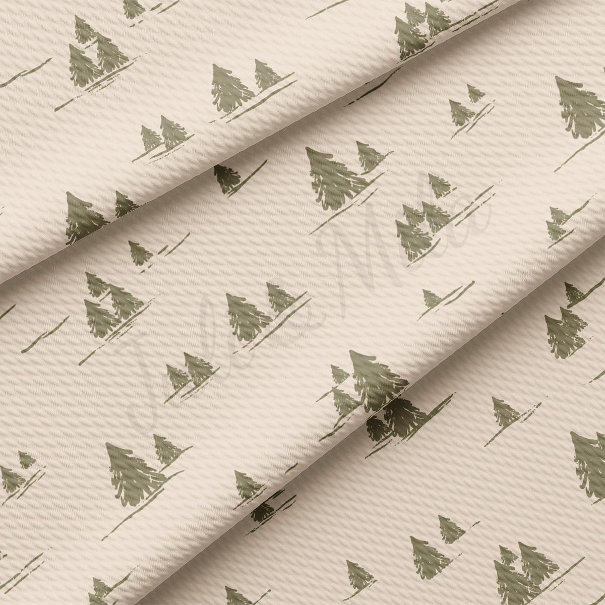 a close up of a white fabric with trees on it