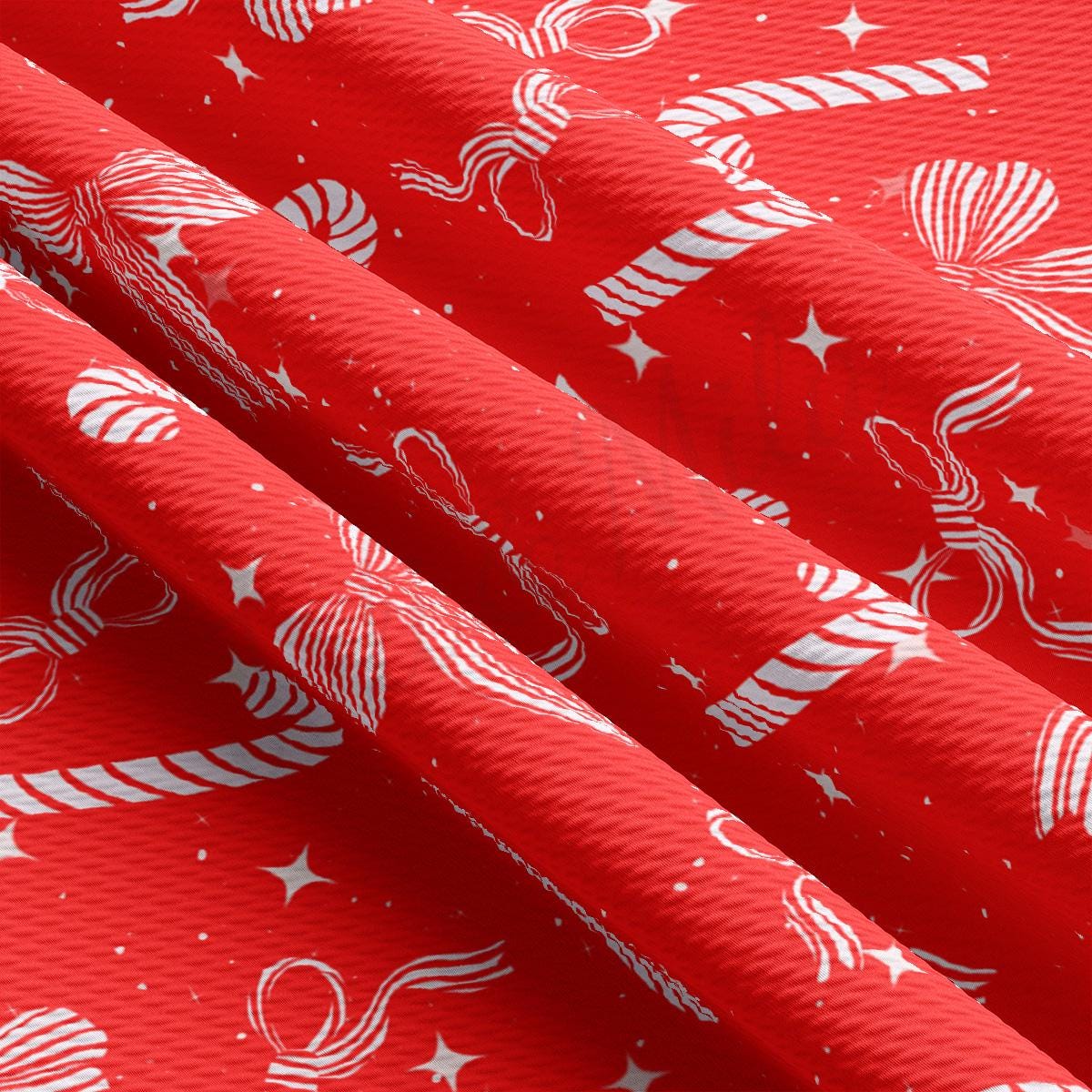 a close up of a red background with white stars and candy canes