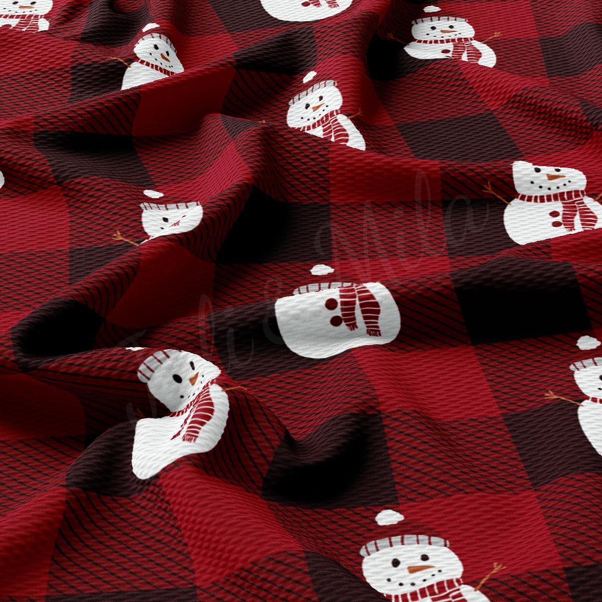 a red and black plaid fabric with snowmen on it