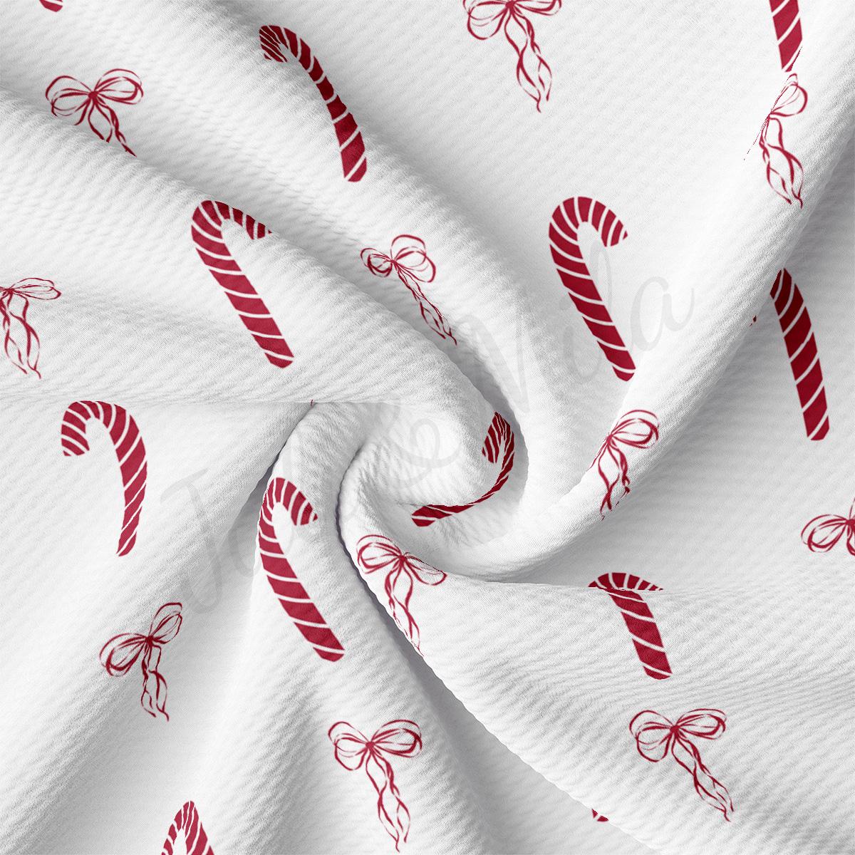 a white fabric with red candy canes on it