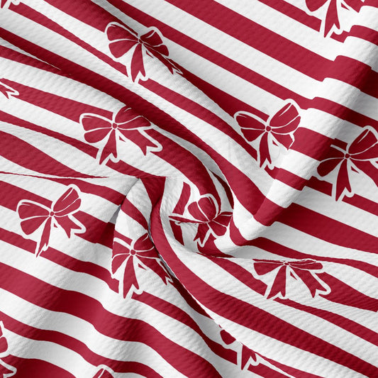 a red and white striped fabric with bows