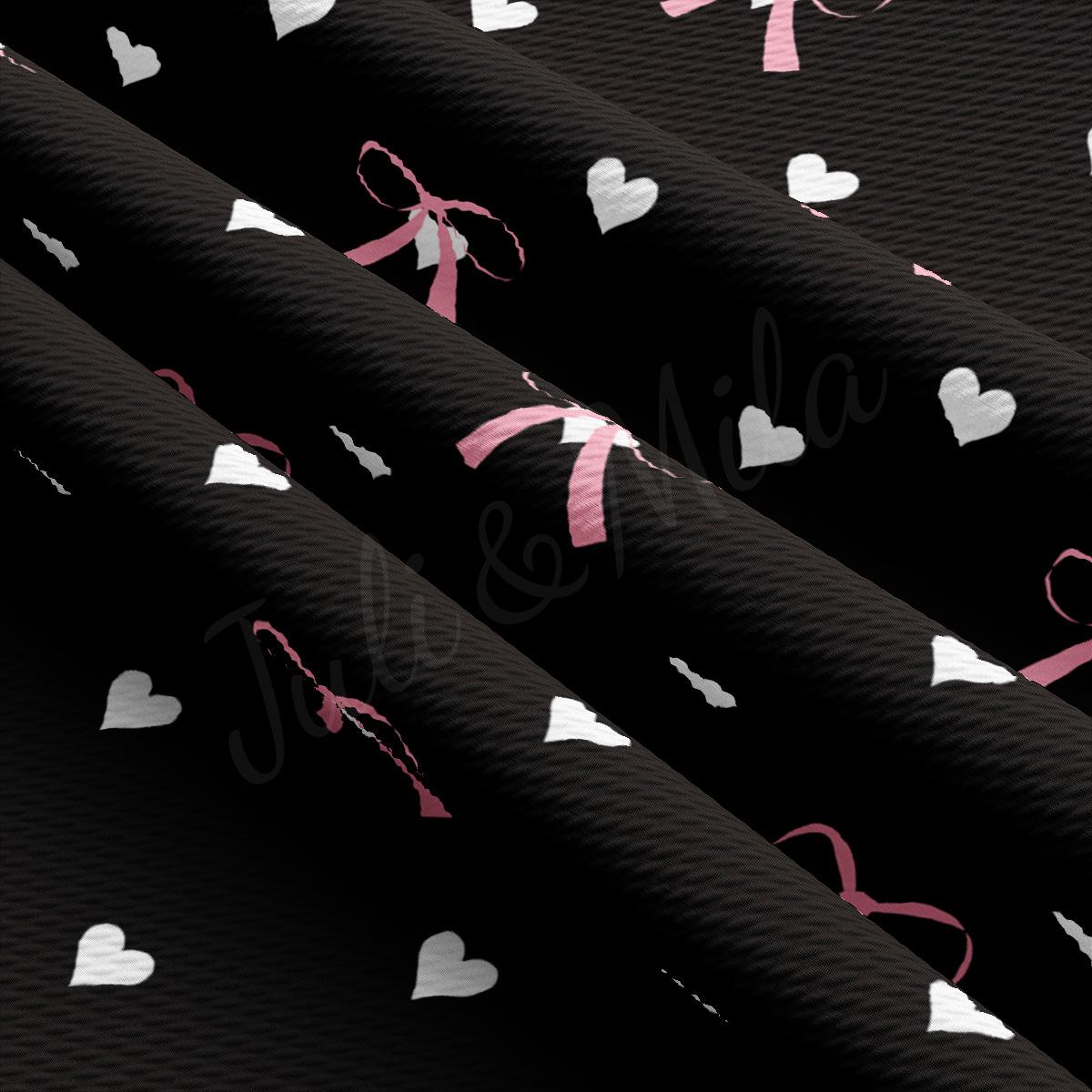 a black background with white hearts and a pink ribbon