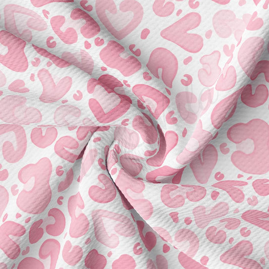 a pink and white fabric with hearts on it