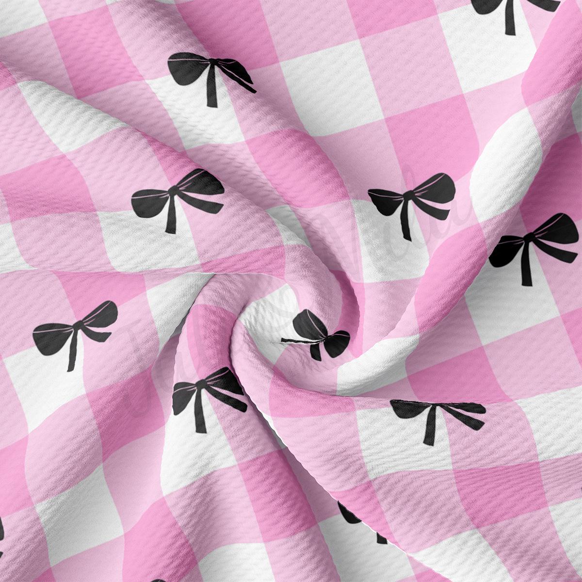 a pink and white checkered fabric with black bows