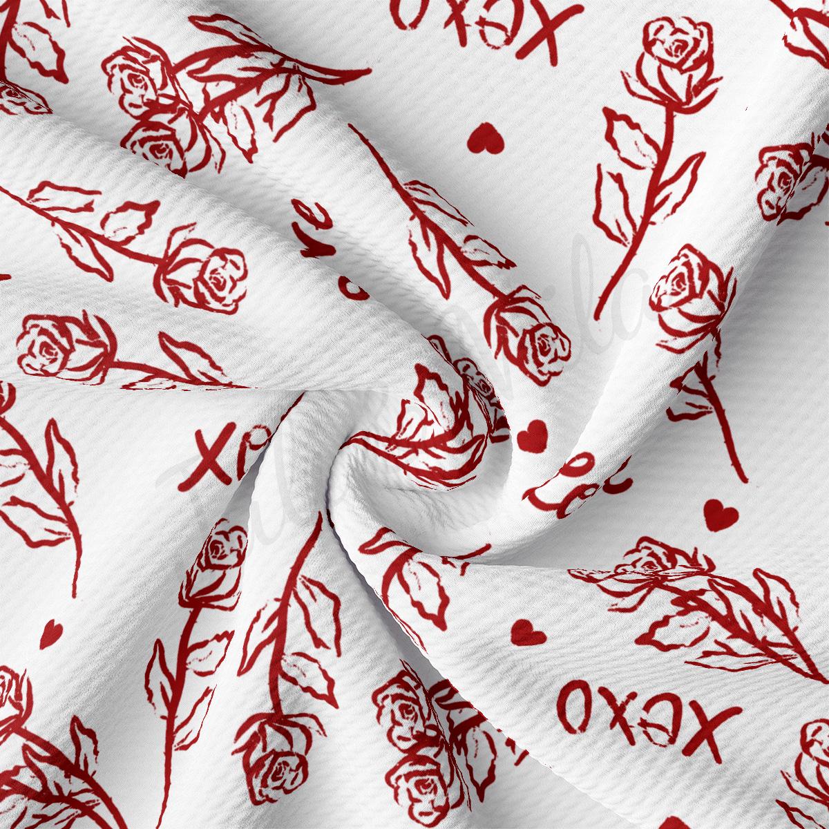 a white fabric with red roses and hearts on it