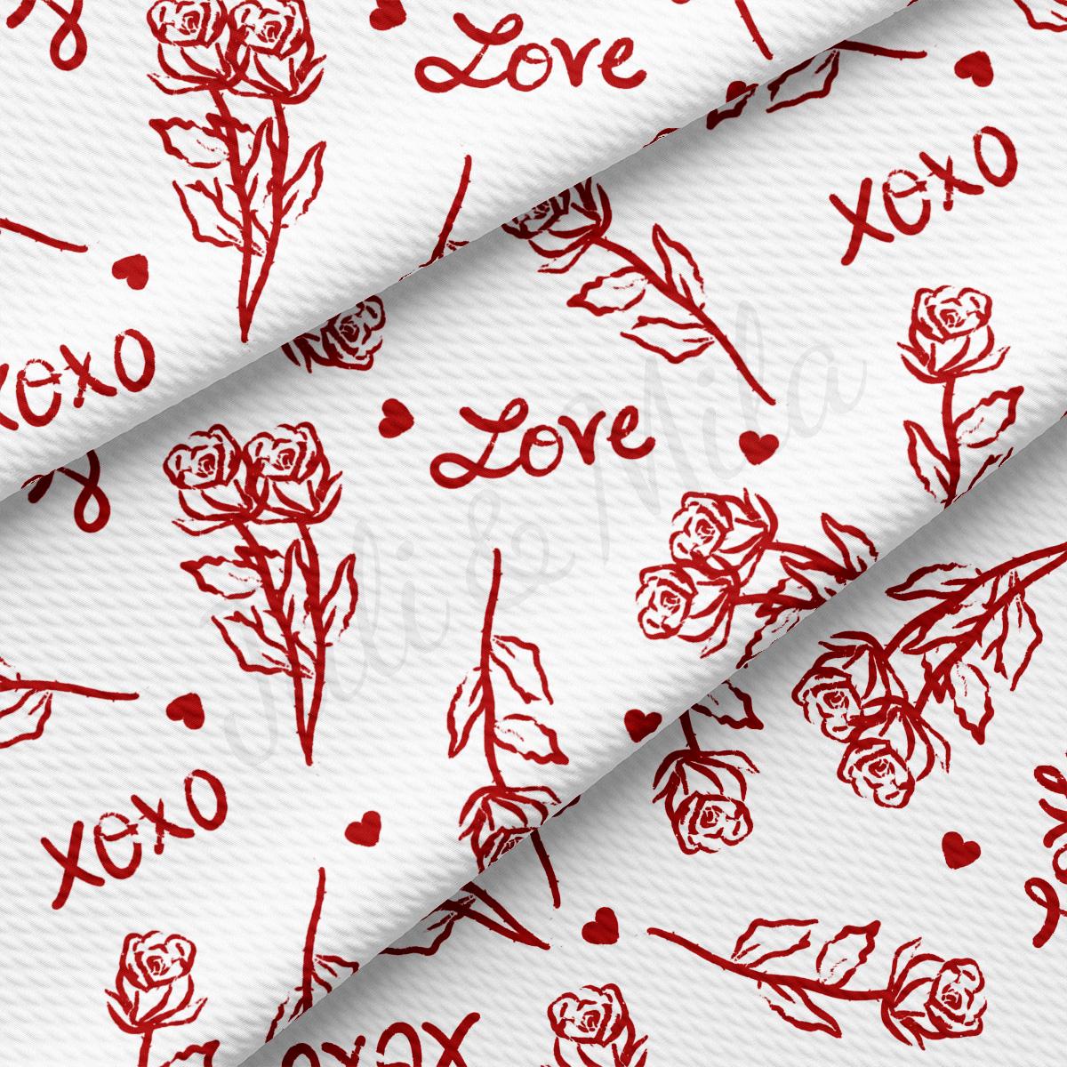 a white fabric with red roses and hearts on it