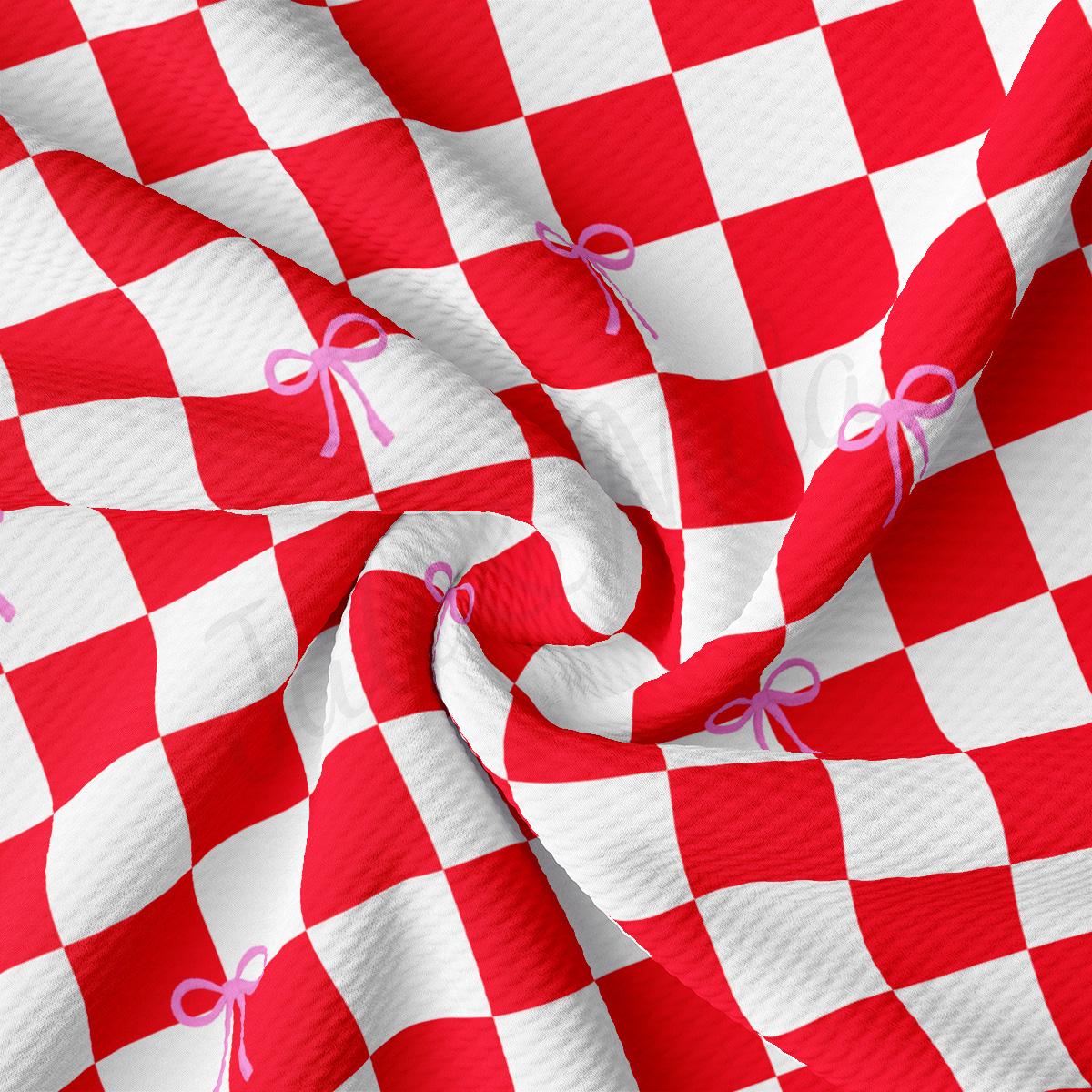 a red and white checkered fabric with a pink bow