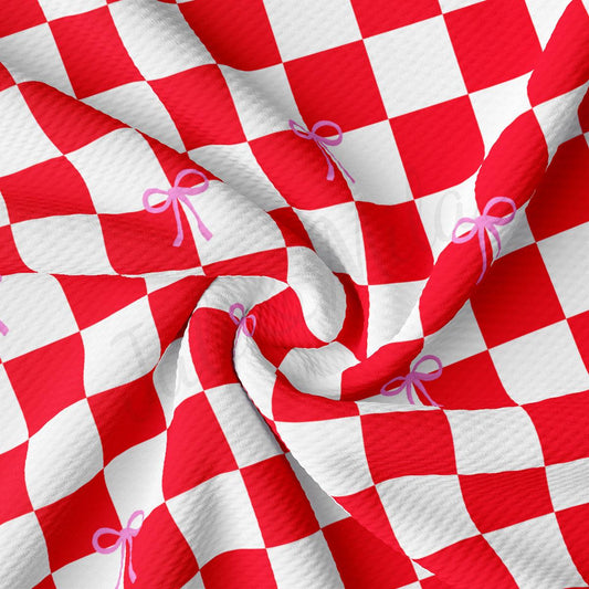 a red and white checkered fabric with a pink bow