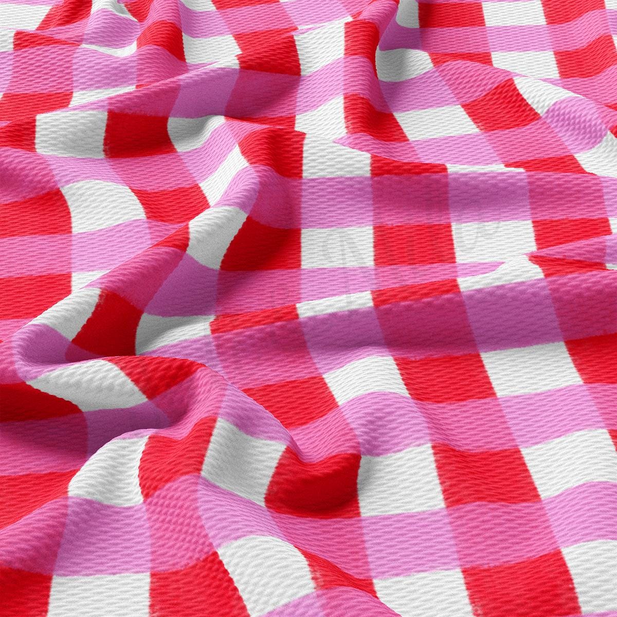 a pink and white checkered fabric with a red stripe