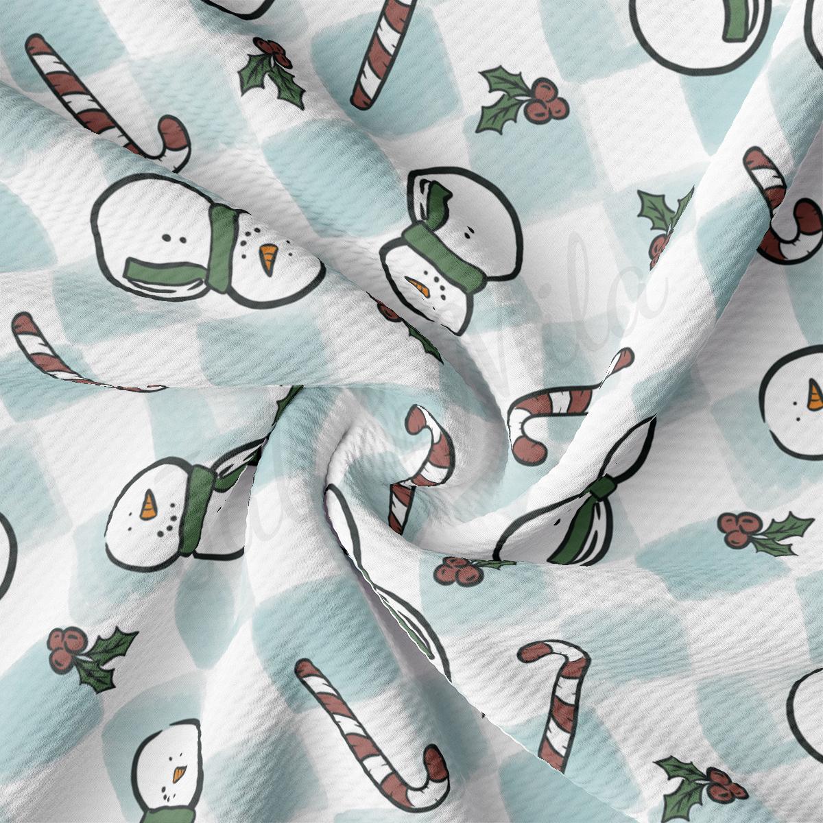 a blue and white checkered fabric with snowmen and candy canes