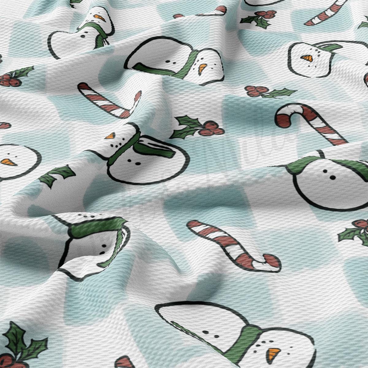 a pattern of snowmen and candy canes on a blue background