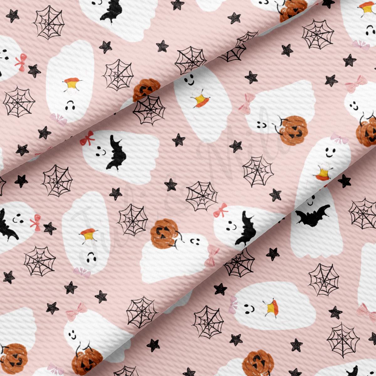a pink background with black and white halloween decorations
