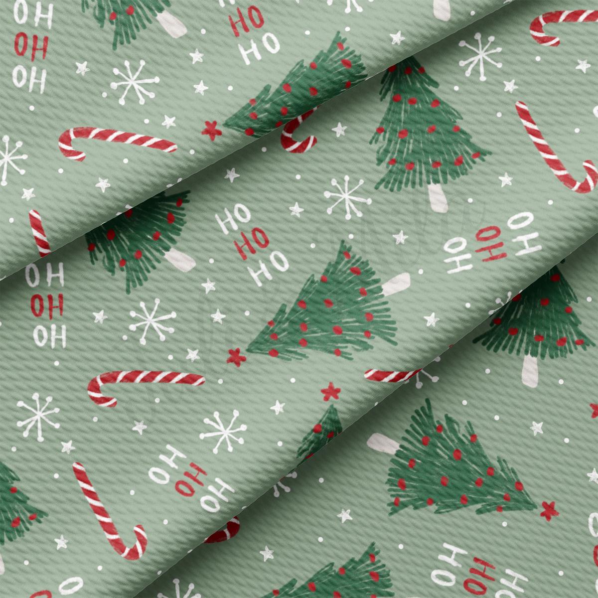 a green wrapping paper with christmas trees and candy canes