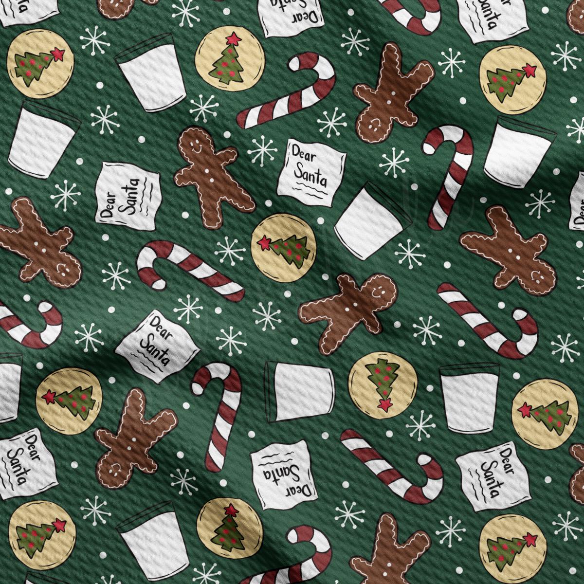 a green christmas wrapping paper with gingerbreads and candy canes